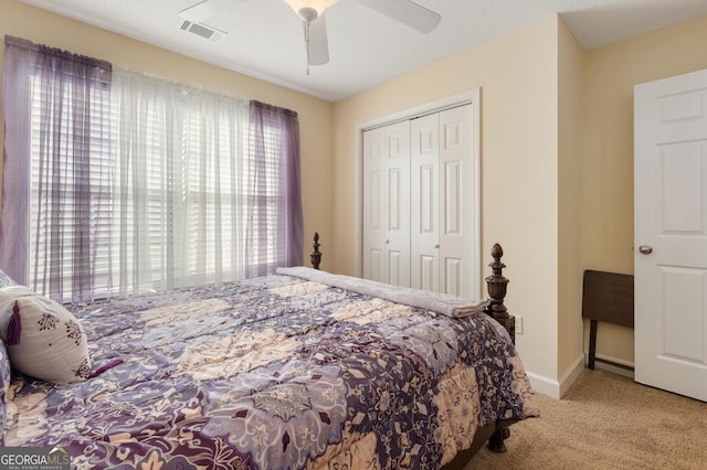 bedroom featuring ceiling fan, carpet flooring, visible vents, baseboards, and a closet