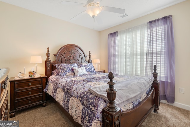 carpeted bedroom with ceiling fan, visible vents, and baseboards