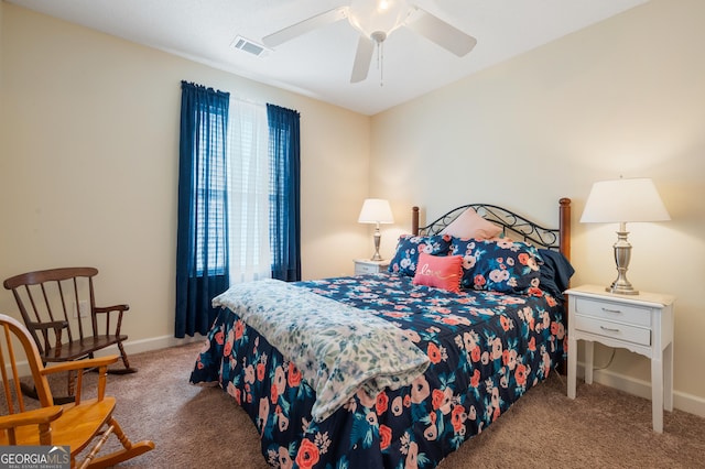 carpeted bedroom featuring a ceiling fan, visible vents, and baseboards