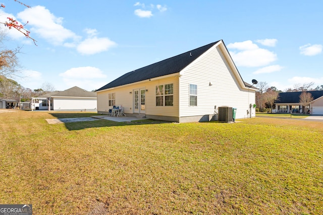 rear view of property with central air condition unit, a yard, and a patio