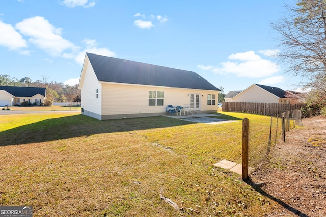 back of property with a lawn, a patio area, and fence