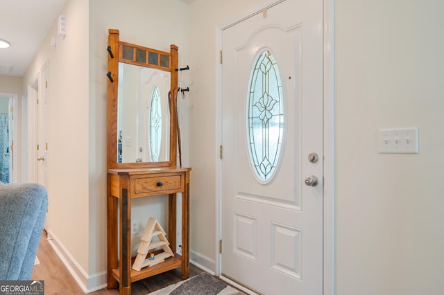 entrance foyer with visible vents, baseboards, and wood finished floors