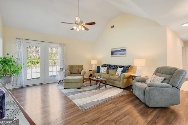 living area with high vaulted ceiling, wood finished floors, visible vents, and a ceiling fan