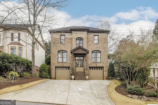 view of front of property featuring a garage, concrete driveway, and brick siding