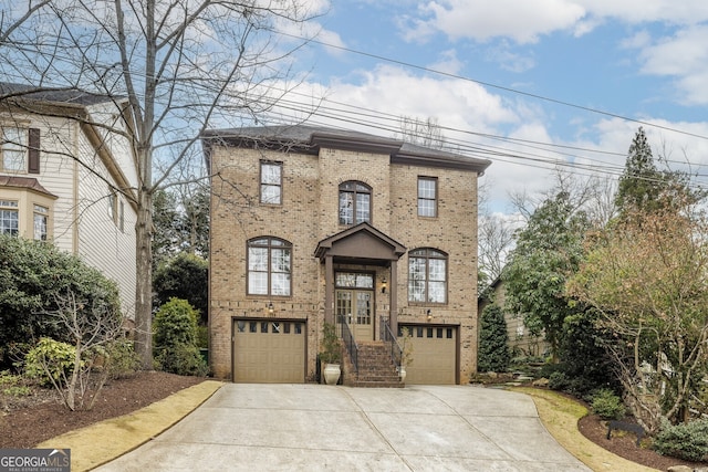 view of front facade featuring a garage, concrete driveway, and brick siding