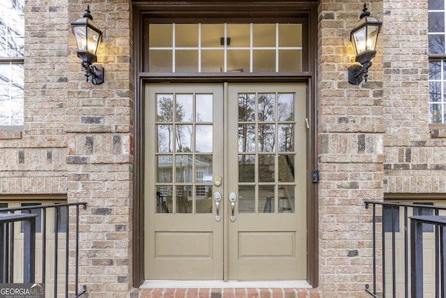 property entrance with french doors and brick siding