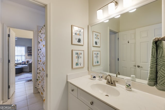 bathroom with tile patterned flooring, crown molding, and vanity