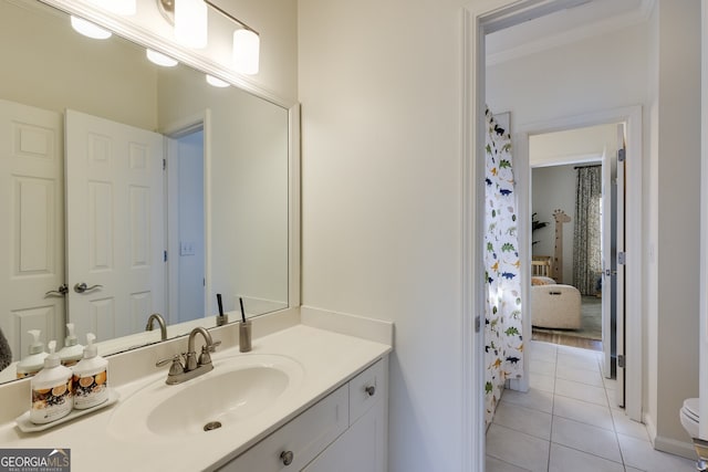 full bathroom with crown molding, vanity, and tile patterned floors