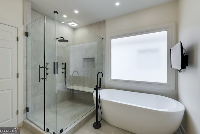 full bathroom with a stall shower, a soaking tub, tile patterned flooring, and recessed lighting