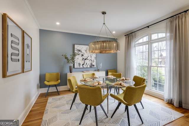 dining area with recessed lighting, crown molding, baseboards, and wood finished floors