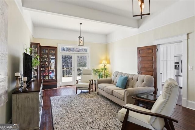 living room with dark wood-type flooring, french doors, and baseboards