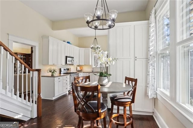 dining area with dark wood-style floors, stairway, baseboards, and an inviting chandelier