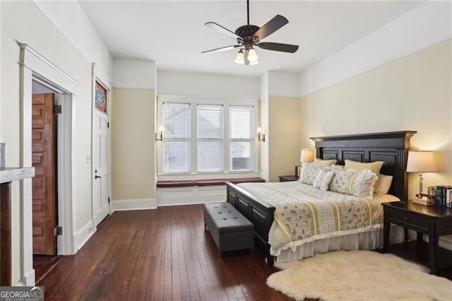 bedroom featuring dark wood-style floors, baseboards, and a ceiling fan