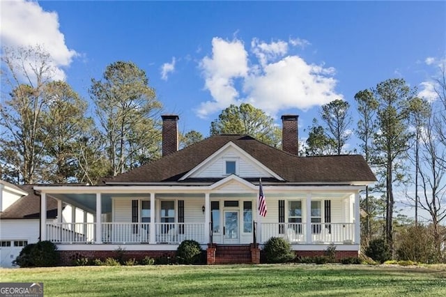 farmhouse-style home featuring covered porch, a chimney, and a front yard