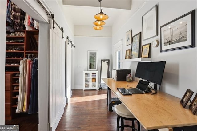 office space featuring dark wood-style flooring and a barn door