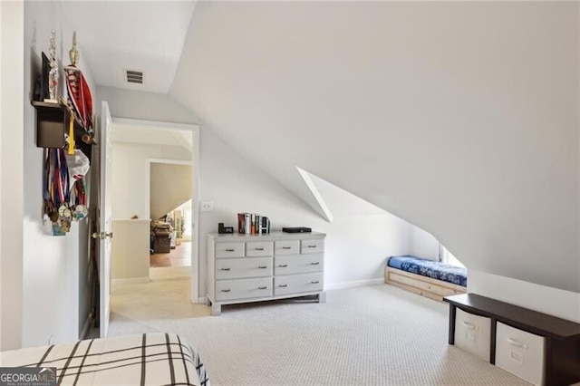 carpeted bedroom featuring visible vents and vaulted ceiling