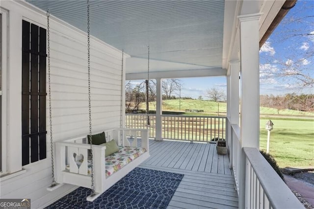 wooden terrace featuring a yard