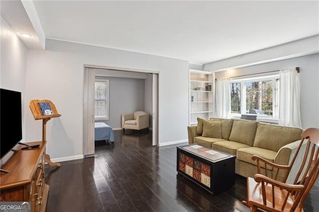 living room featuring hardwood / wood-style flooring and baseboards