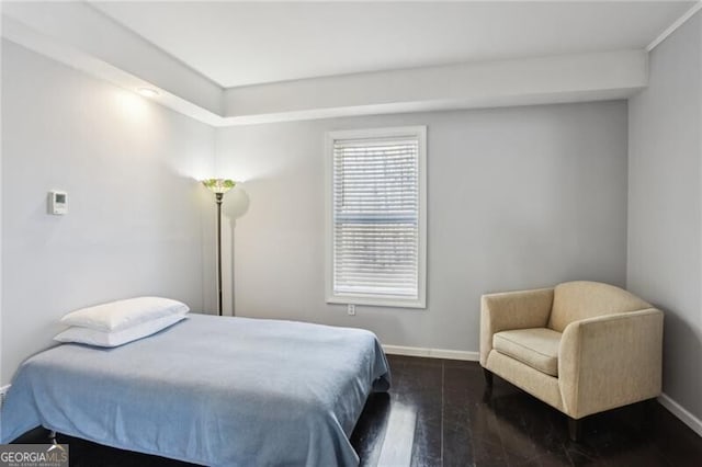 bedroom with dark wood finished floors and baseboards