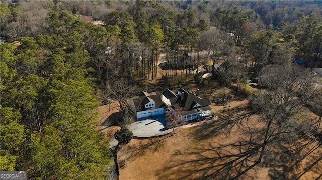 drone / aerial view featuring a forest view