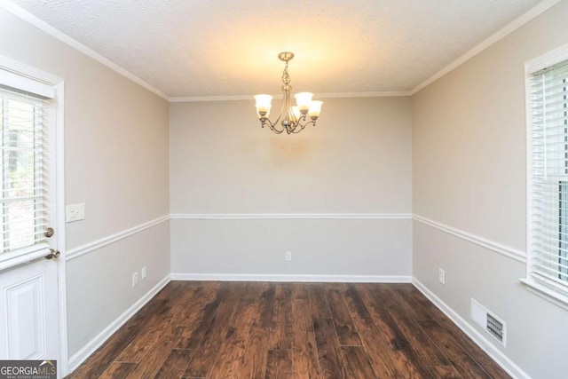 unfurnished dining area featuring a wealth of natural light, visible vents, an inviting chandelier, and wood finished floors