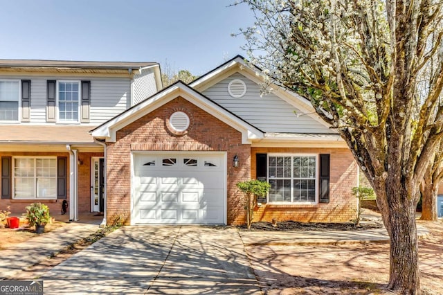 traditional-style home featuring brick siding, driveway, and an attached garage