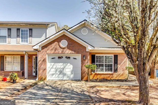 2139 Hickory Bnd SE Unit E, Conyers, GA 30013 - view of front facade with brick siding, driveway, and an attached garage