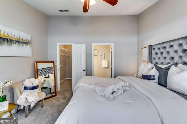 2139 Hickory Bnd SE Unit E, Conyers, GA 30013 - carpeted bedroom featuring a walk in closet, ceiling fan, lofted ceiling, and a closet