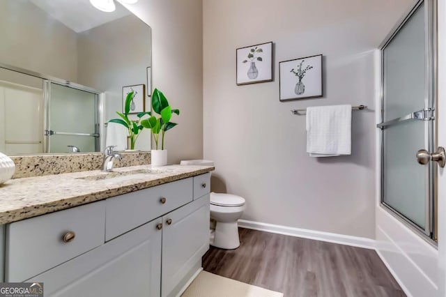 2139 Hickory Bnd SE Unit E, Conyers, GA 30013 - bathroom featuring wood finished floors, vanity, and enclosed tub / shower combo