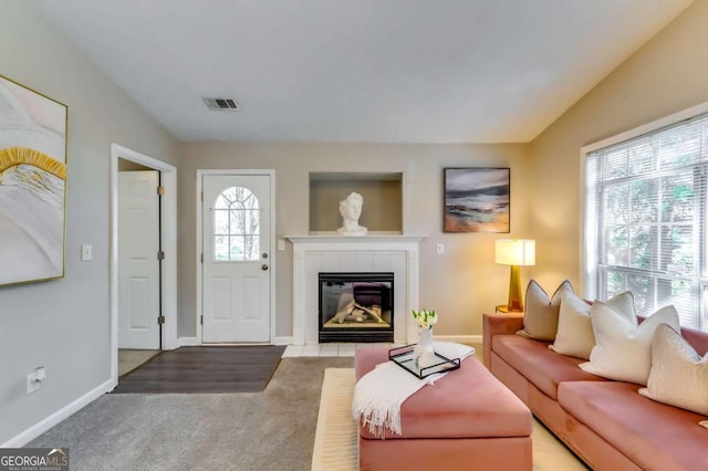 2139 Hickory Bnd SE Unit E, Conyers, GA 30013 - carpeted living area featuring a tile fireplace and baseboards