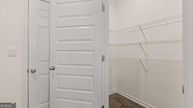 1069 Blue Juniper Cir, Loganville, GA 30052 - spacious closet featuring dark wood-style floors