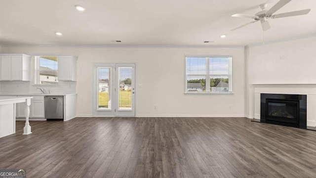 1069 Blue Juniper Cir, Loganville, GA 30052 - unfurnished living room featuring recessed lighting, baseboards, dark wood finished floors, and a glass covered fireplace