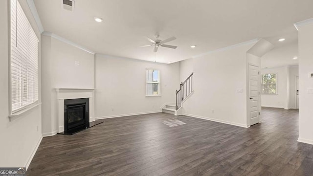 1069 Blue Juniper Cir, Loganville, GA 30052 - unfurnished living room featuring stairs, visible vents, ornamental molding, and a glass covered fireplace