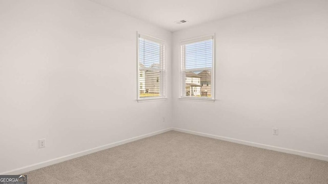 1069 Blue Juniper Cir, Loganville, GA 30052 - empty room with carpet floors, visible vents, and baseboards