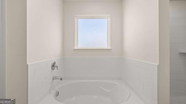 1069 Blue Juniper Cir, Loganville, GA 30052 - bathroom with a garden tub