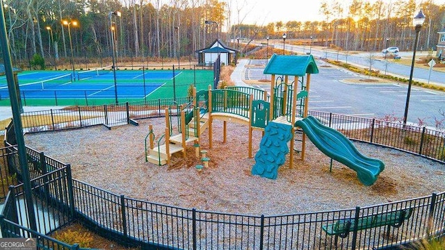 1069 Blue Juniper Cir, Loganville, GA 30052 - communal playground with a tennis court and fence