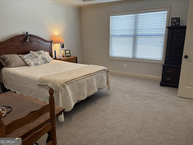 bedroom with ornamental molding, light carpet, and baseboards