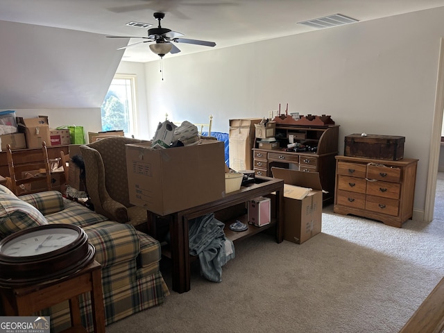 interior space featuring ceiling fan, carpet, visible vents, and vaulted ceiling