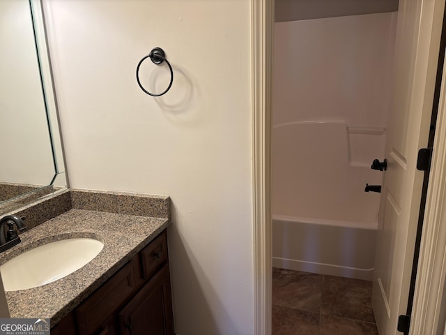 bathroom with tile patterned flooring, shower / bathing tub combination, and vanity