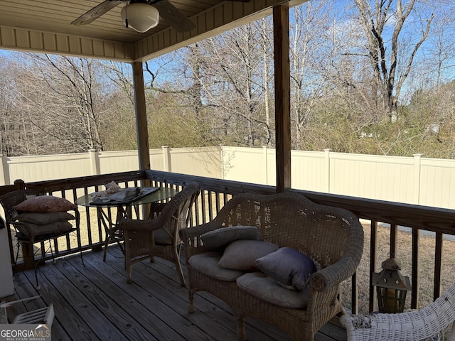 wooden deck featuring a fenced backyard and a ceiling fan