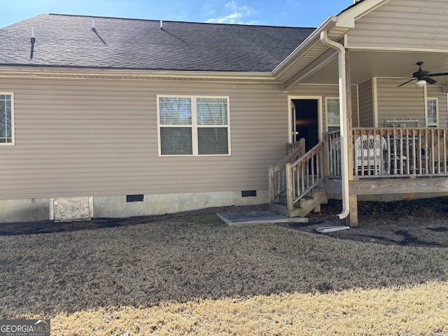 entrance to property featuring crawl space, ceiling fan, a lawn, and roof with shingles