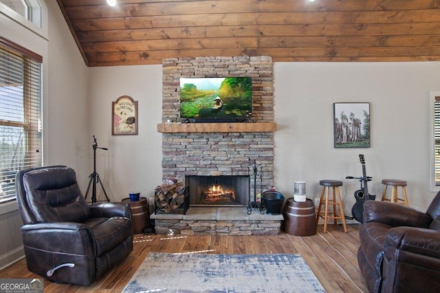 living room featuring a fireplace, wood finished floors, wood ceiling, baseboards, and vaulted ceiling