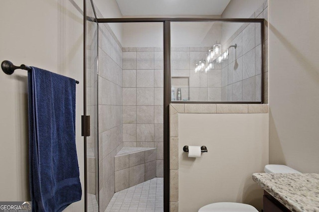 bathroom featuring toilet, a stall shower, and vanity