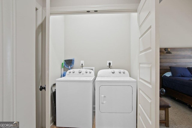 clothes washing area featuring laundry area, carpet, and washing machine and dryer