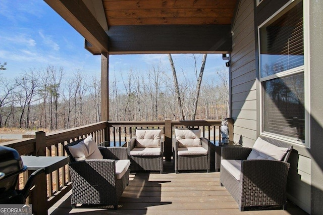 wooden deck with an outdoor living space