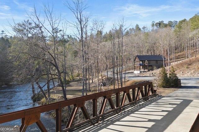 wooden terrace with a view of trees