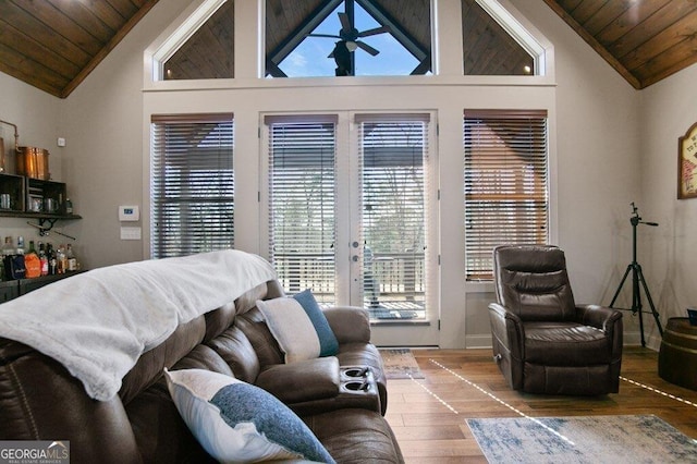 bedroom with wood ceiling, access to outside, wood finished floors, and french doors