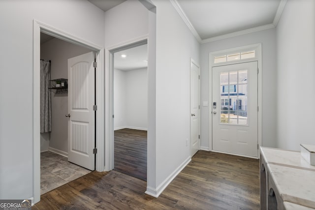 foyer with ornamental molding, dark wood-style flooring, and baseboards