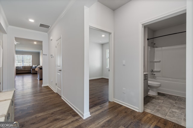 hall with crown molding, recessed lighting, visible vents, dark wood-type flooring, and baseboards