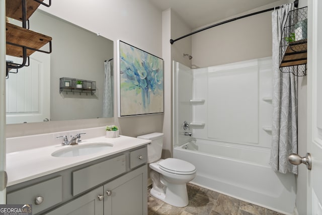 bathroom with shower / tub combo, vanity, and toilet